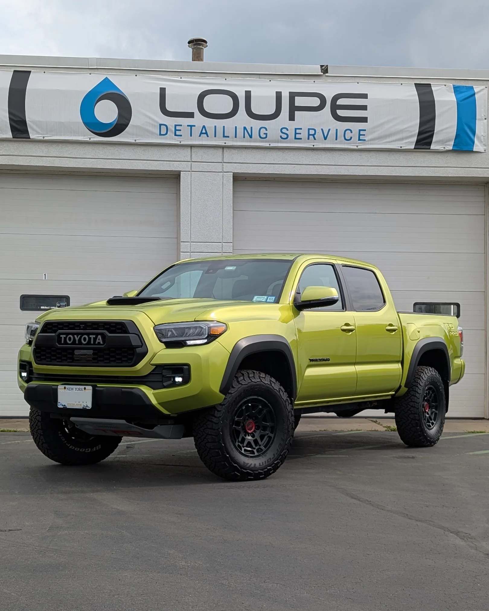 Bright green Toyota Tacoma TRD Pro parked at Loupe Detailing in Amherst NY after ceramic coating service